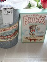 Metal pail and Borax box on tile floor