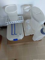 All eight plastic storage items grouped on box