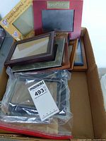 Box with multiple wood and metal frames, glass fronts visible