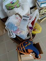 Overall lot showing basket, glue gun, tin, bagged ornaments