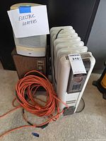 All three heaters and coiled orange extension cord grouped together