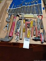 Overview of assorted hand tools laid on bench