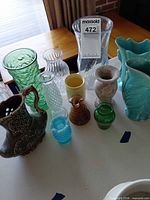 Full group of 11 mixed glass, ceramic and stone vases and pitchers on table
