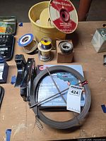 overview showing stapler, steel strapping coil, wire spools, GE red-label spool