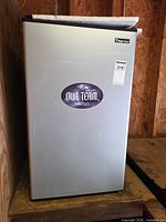 Front view of Magic Chef silver compact refrigerator with team decal and model sticker visible