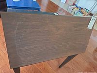 Top view showing dark walnut finish with circular ring mark and wood grain