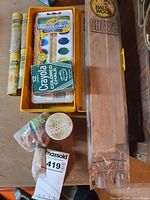 Overview showing watercolor set, chalk, glitter tubes, glitter jar and balsa wood sheets