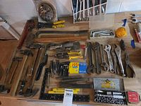 Overall view of assorted hand tools laid out on bench