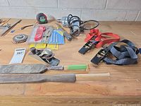 Overview of tools on workbench including drill, plane, rasps, straps, tape measures, drill bits