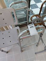 Shower chair, partial walker frame, two wooden canes hooked