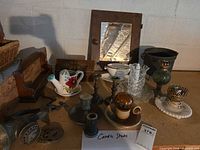 Overall shot of lot showing pitcher, mirror door, grinder, glassware, lamp parts, candlesticks
