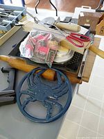 Group shot showing Nordic Ware pan, crab trivet, rolling pin, utensils, matches and clips