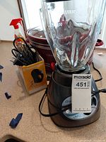 Oster blender, Crock-Pot slow cooker, Toastmaster hand mixer box and accessories on countertop