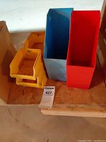 group of two yellow small bins with blue and red vertical bins beside