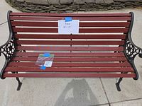 Front view of red slat bench showing full width and seat condition