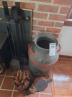 overall view showing milk can, fireplace tools on stand, bellows and bucket