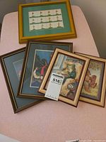 Overview of all five framed prints on table