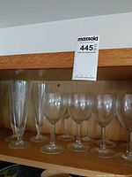 Set of champagne flutes and wine glasses on shelf