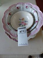 Stack of varying floral porcelain pieces showing bowl and plates
