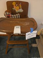 Full view of wooden high chair with tray and auction tag