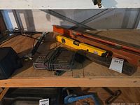 shelf view showing both levels, clock radio, cords, mallet block