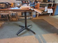 Overall view of rectangular wood veneer top table with black metal pedestal base