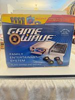Front of sealed Game Wave console box