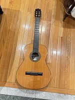 Full view of Bravo BC-400 classical acoustic guitar on floor