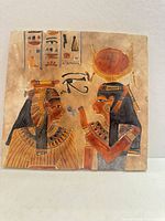 Front view of carved and painted stone plaque depicting two Egyptian figures and hieroglyphs