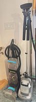 Conair garment steamer standing beside Bissell cleaner