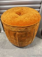 Angled front view showing overall cylindrical shape and upholstery