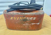 Front view of Evinrude metal gas tank showing logo and wear