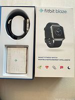 Box interior showing watch and paperwork