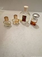 All four miniature perfume bottles lined up