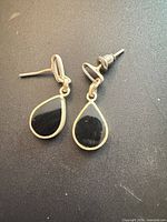 Front view showing both earrings with black side outward