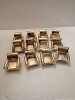 All 12 silver-plated miniature armchair place card holders grouped
