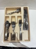 Cutlery set in beige organizer showing all pieces stacked in their respective slots