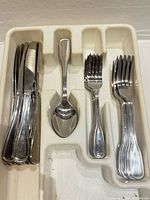 Flatware set in organizer showing knives, spoon, forks