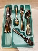 Flatware pieces arranged in organizer, showing quantity and types