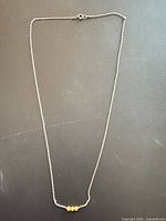 Full view of sterling silver necklace showing length and bead placement