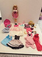Full lot layout showing doll, multiple outfits and accessories
