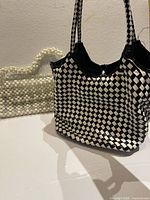 Front view showing both handbags: beaded evening bag and checkerboard tote
