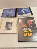 Group shot of four discs showing covers and cases