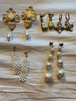 All five pairs of earrings laid out on fabric