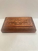 Top view of carved wooden jewelry box lid