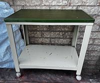 Full view of cart showing green top, white frame and lower shelf