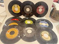 Group shot of all eleven 7-inch singles showing label variety