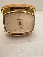 Front view of Rensie travel clock showing dial, bezel and case
