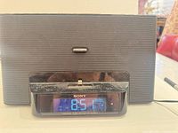 Front view showing Sony Dream Machine with dock and digital time display