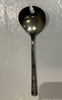 Full view of salad serving spoon showing overall design